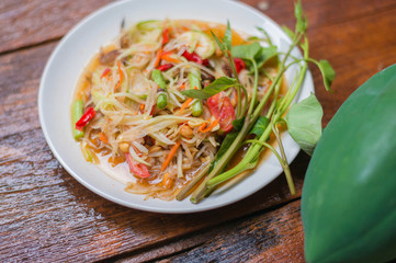 Thai food Papaya salad Spicy flavor On the old wood table