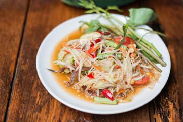 Thai food Papaya salad Spicy flavor On the old wood table