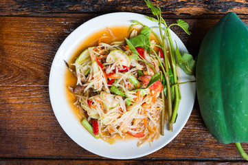 Thai food Papaya salad Spicy flavor On the old wood table