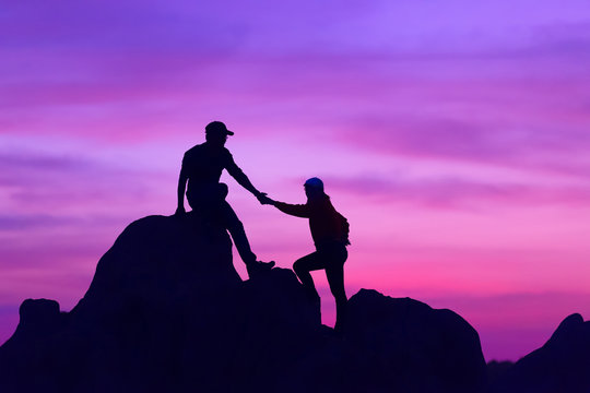 The joint work teamwork of two men travelers help each other on top of a mountain climbing team,teamwork concept.