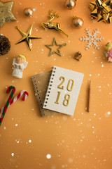 Christmas holiday background with gold ornaments and decorations. Merry christmas and happy new year greeting card with copy space. Christmas celebration holiday background.