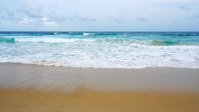 tropical andaman seascape scenic off kata beach phuket thailand with wave crashing on sandy shore