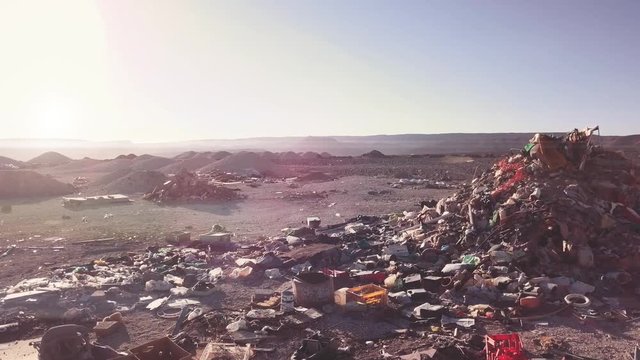 Aerial view of huge piles of trash in the desert. 4k