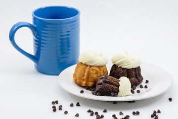Cupcakes on white plate with coffee and white space for text