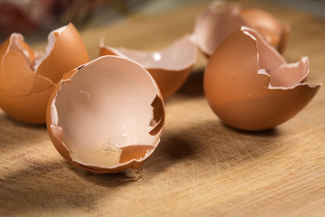 Empty egg shells on wooden cutting board
