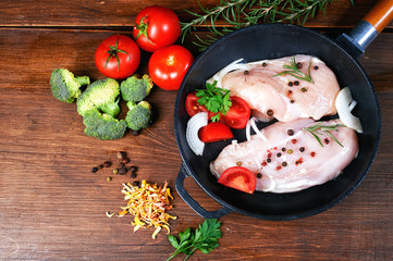 Raw chicken fillet with vegetables , spices and rosemary