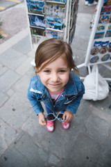Naklejka premium Girl Holding Sunglasses in Street