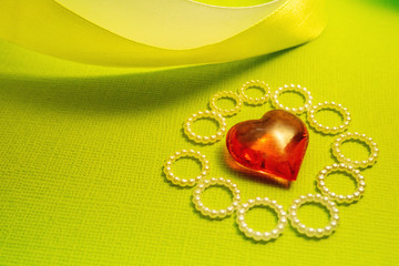 curving the glass ribbon and heart on a green background, a Declaration of love and congratulations