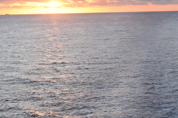 Obraz premium The Clouds and Sun Rising over the Ocean