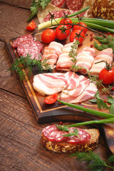 Delicatessen, smoked meat, bacon, vegetables, tomatoes, greens