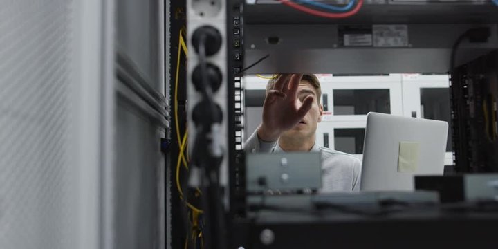 A Man Working In A Server Room. Shot on RED Helium 8K