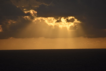 Fototapeta premium Sun Rays Peering from Dark Clouds