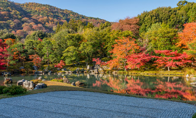 Beautiful colour leaves and reflection in the pond at Tenryuji temple, Arashiyama, Kyoto, Japan in autumn season.