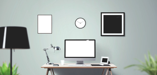 Computer display and office tools on desk.