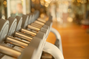 Rows of dumbbells in the gym