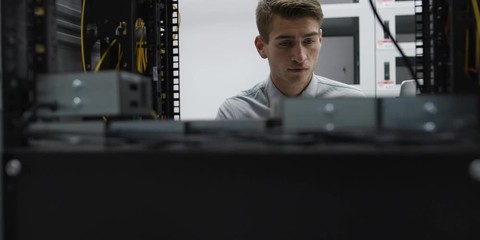 A Man Working In A Server Room. Shot on RED Helium 8K
