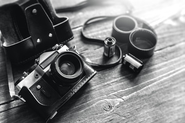 Retro photo camera on a stylish wooden background with different photo related items