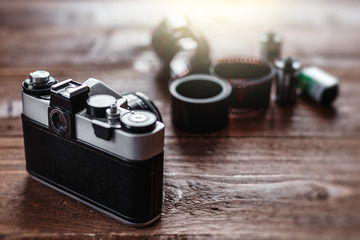 Retro photo camera on a stylish wooden background with different photo related items