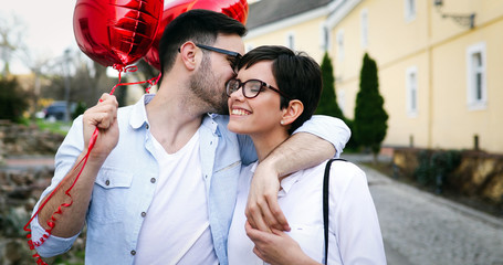 Naklejka premium Couple hugging and kissing outdoors