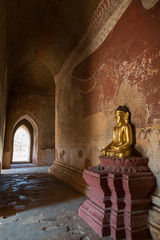 Golden Buddha statue, big Buddha mural and corridor inside the Sulamani temple in Bagan, Myanmar (Burma).