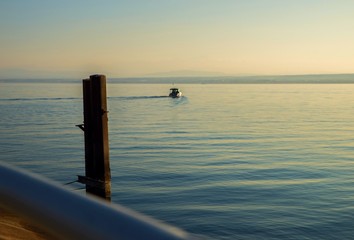 Boat departs to the horizon.