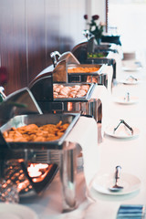 Buffet lunch with chafing dishes and dinnerware