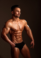 Fototapeta na wymiar Athletic bodybuilder man on black background.