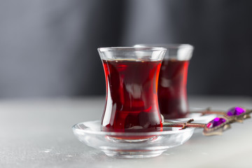 Red tea in turkish glasses on a wooden table