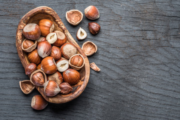 Filberts or hazelnuts in the wooden bowl on the table.