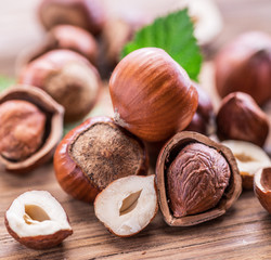 Hazelnuts and hazelnut leaves on the wooden table.
