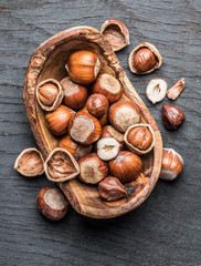 Filberts or hazelnuts in the wooden bowl on the table.