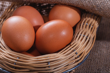 Easter composition. A few eggs in a beautiful basket from willow closeup