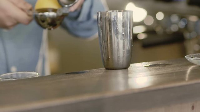 A lemon squeezing for cocktail. Slowly