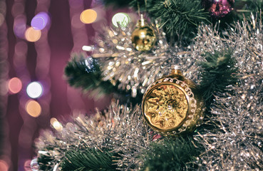 Unusual hemisphere on a Christmas tree in shiny tinsel garland with on blurred background