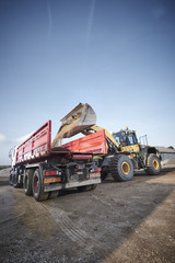 Excavator moving sand and gravel 