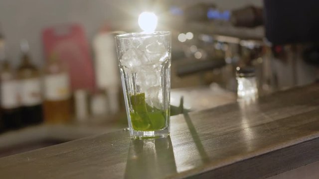A glass with ce cubes and mint for cocktail. 4K