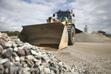 Excavator moving sand and gravel 