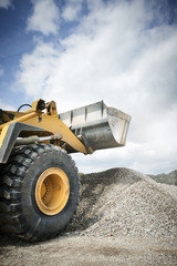 Excavator moving sand