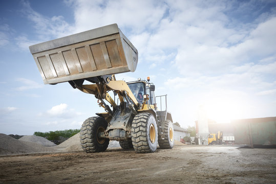 Excavator moving sand