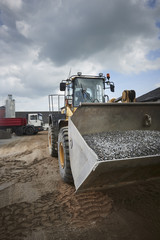 Excavator moving sand