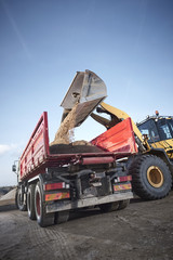 Excavator moving sand