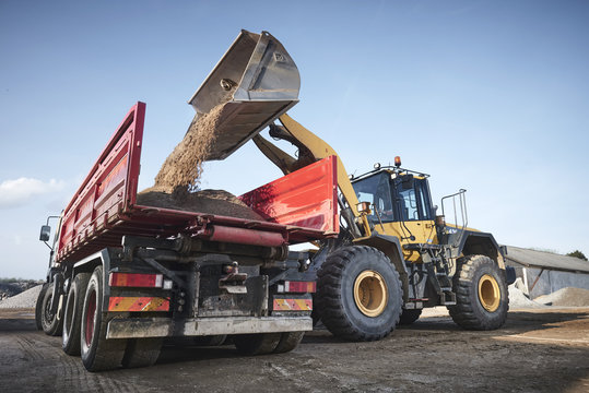 Excavator moving sand