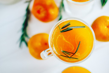 Tangerine panna cotta dessert with rosemary in wineglasses