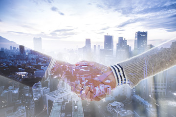 Close up image of business partners handshake over office desk during meeting or negotiation. 