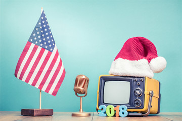 Retro TV in Santa hat with New Year 2018 date, microphone and USA flag front mint green background....