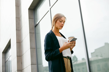 Young Woman Using Phone Outdoors.