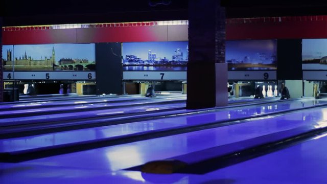 Modern Colorful bowling alley. Group game. Bowling strike competition. Spacious hall with a lot of game tracks