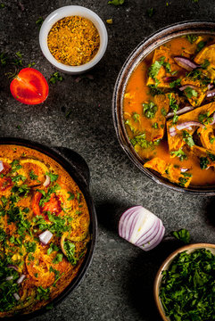 Indian food recipes, Masala Omelette with and Indian Omelet Masala Egg Curry, with fresh vegetables - tomato, hot chili pepper, parsley dark stone background, copy space top view