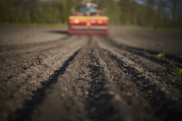 Red tractor plow field