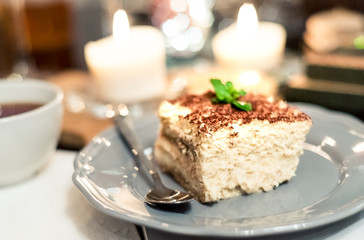 tiramisu by candlelight, romantic date in Italy, tiramisu dessert on a porcelain plate